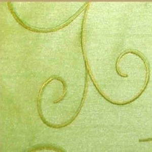 Light green textured fabric with delicate, curving golden swirl design.
