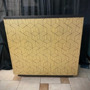 Gold geometric cube pattern room divider with hexagonal line design on textured surface.