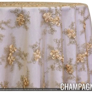 Champagne gold embroidered lace tablecloth overlay with delicate floral embellishments on sheer fabric.