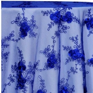 Sheer royal blue lace fabric with embroidered floral pattern and intricate vine details.