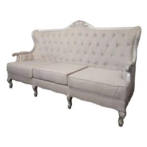 Antique white tufted French provincial sofa with curved frame and elegant upholstery.