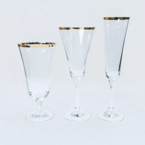 Three elegant champagne flutes with gold-rimmed rims in graduated sizes on white background.