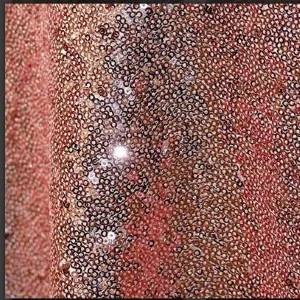 Shimmering burgundy sequin fabric with metallic texture creates glamorous event backdrop.