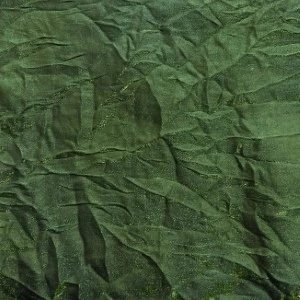 Wrinkled forest green fabric with textured, crumpled surface for event linen rentals.