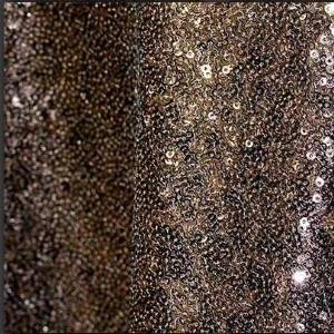 Glittery bronze sequin fabric with dense, shimmering texture for glamorous event decor.