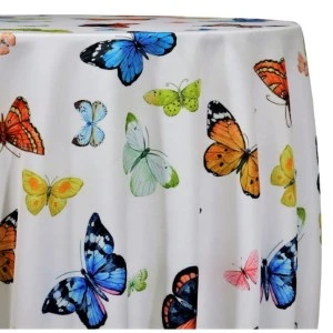 White fabric tablecloth with colorful butterfly print in blue, orange, yellow, and green.