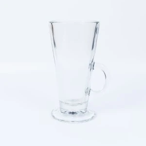 Clear glass tall latte mug with curved handle on white background.