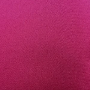 Solid magenta fabric swatch with smooth, uniform texture for event linen rentals.