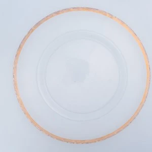 White ceramic dinner plate with delicate peach-gold rim on light background.