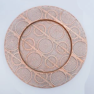 Rose gold charger plate with intricate circular lace-like laser-cut pattern and delicate textured design.