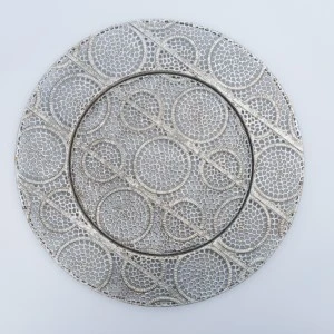 Silver metallic charger plate with intricate circular lace-like pattern and delicate textured design.
