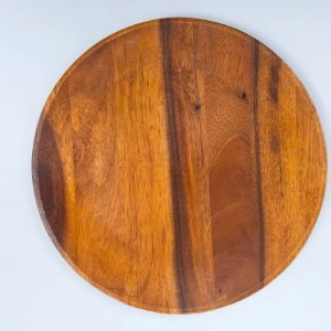 Round wooden serving board with warm brown tones and vertical wood grain pattern.