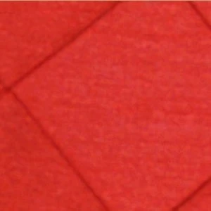 Bright red fabric with soft folded texture and geometric diagonal crease lines.