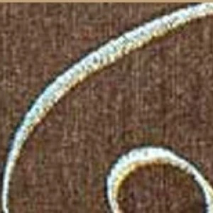 Textured brown fabric with curved white and gold stitched border design.