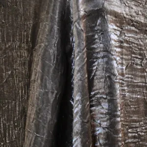 Dark bronze textured metallic fabric with deep vertical creases and shimmering shadowed surface.