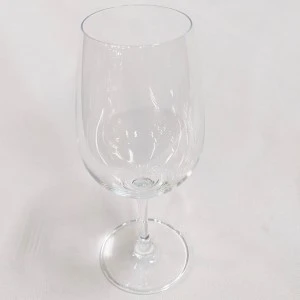 Clear wine glass with slender stem on white background for elegant event rentals.
