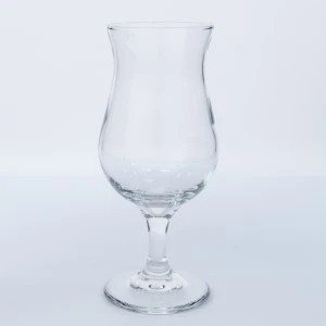 Clear glass hurricane cocktail stemmed glassware with curved tulip-shaped bowl on white background.