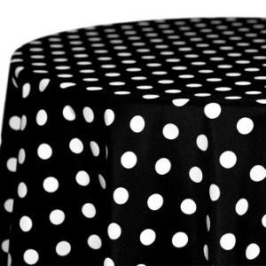 Black tablecloth with white polka dots draped in elegant folds for event rentals.