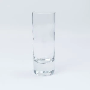 Tall clear glass tumbler with thick sturdy base on white background.