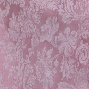 Dusty rose damask fabric with elegant floral and scrollwork texture for wedding linens.