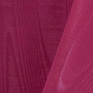Magenta textured fabric with soft folds and ribbed surface in elegant event linen.