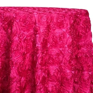 Bright fuchsia rosette tablecloth with textured three-dimensional floral swirl pattern.