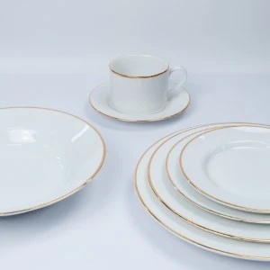 White porcelain dinnerware set with delicate gold rim, featuring plates and teacup.