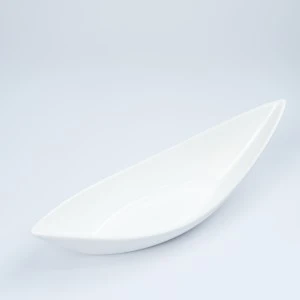 Sleek white ceramic serving spoon with curved modern design on light background.