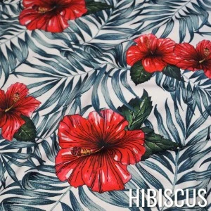 Red hibiscus flowers with green leaves on gray palm leaf print fabric pattern.