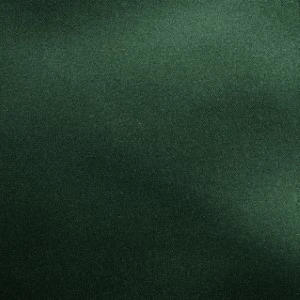 Deep emerald green fabric with soft textural grain and uniform solid color background.