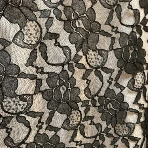 Black floral lace fabric with intricate embroidered pattern on mesh background.