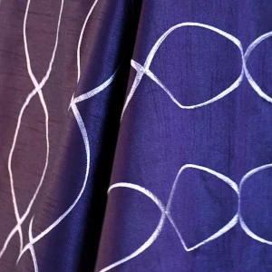 Purple and navy blue fabric with wavy white linear and curved graphic design overlay.