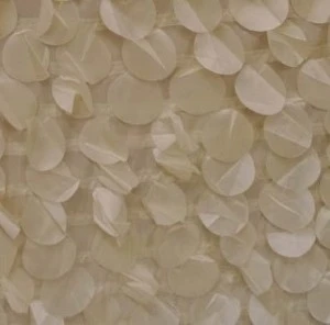 Ivory-toned sea glass or petal-like event decor fabric with soft, translucent overlapping texture.