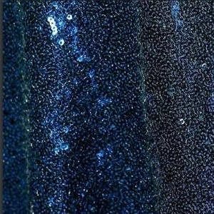Navy blue sequin fabric with textured, shimmering surface creating a glittery, dark glamorous backdrop.