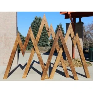 Wooden geometric event display stand with numbered triangular frames in rustic brown tones.