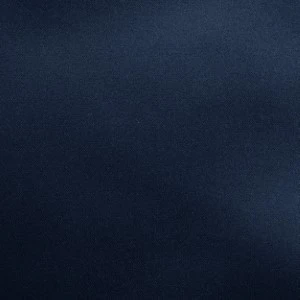 Solid navy blue textured fabric or material with uniform dark blue color.