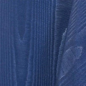 Blue fabric with soft vertical ribbed texture and subtle shimmering folds.