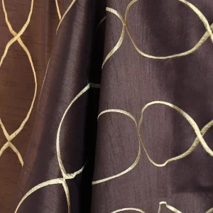 Dark brown fabric with metallic gold curved linear design creates elegant decorative pattern.