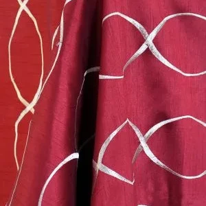 Burgundy fabric with white curved linear embroidery and vertical black accent stripe.