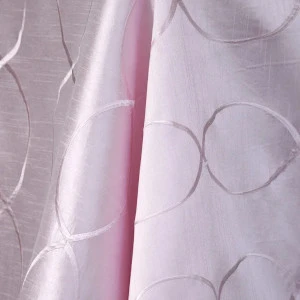 Soft pink sheer drapery fabric with delicate circular embroidered pattern and elegant texture.