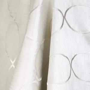 Ivory white textured linen fabric with subtle curved graphic design and soft folds.