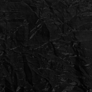 Black crumpled fabric with deep textured wrinkles and shadowy surface.