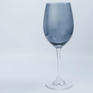 Blue-tinted wine glass with clear stem on white background for event rentals.
