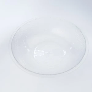 Clear round glass charger plate with smooth, translucent surface for elegant table settings.