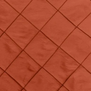 Rust-colored pintuck fabric with diagonal diamond grid pattern and textured surface.
