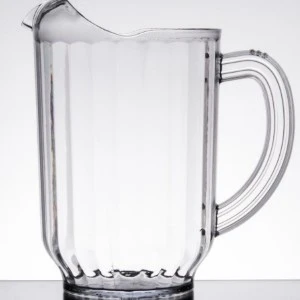 Clear glass beer pitcher with vertical ribbed design and sturdy handle on textured base.