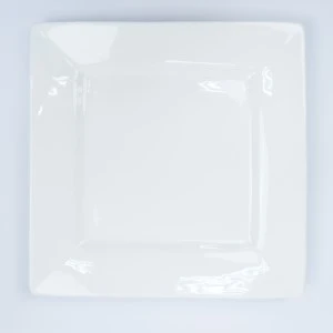 Square white ceramic plate with raised border and glossy finish for event tableware rentals.