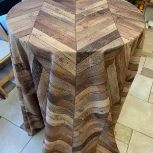 Wooden chevron-patterned tablecloth with rustic gray and brown wood grain textures for event decor.
