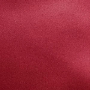 Solid burgundy red textured fabric with subtle sheen for event linen rentals.