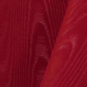Deep red pintuck textured fabric with vertical rippled folds and shimmering surface.